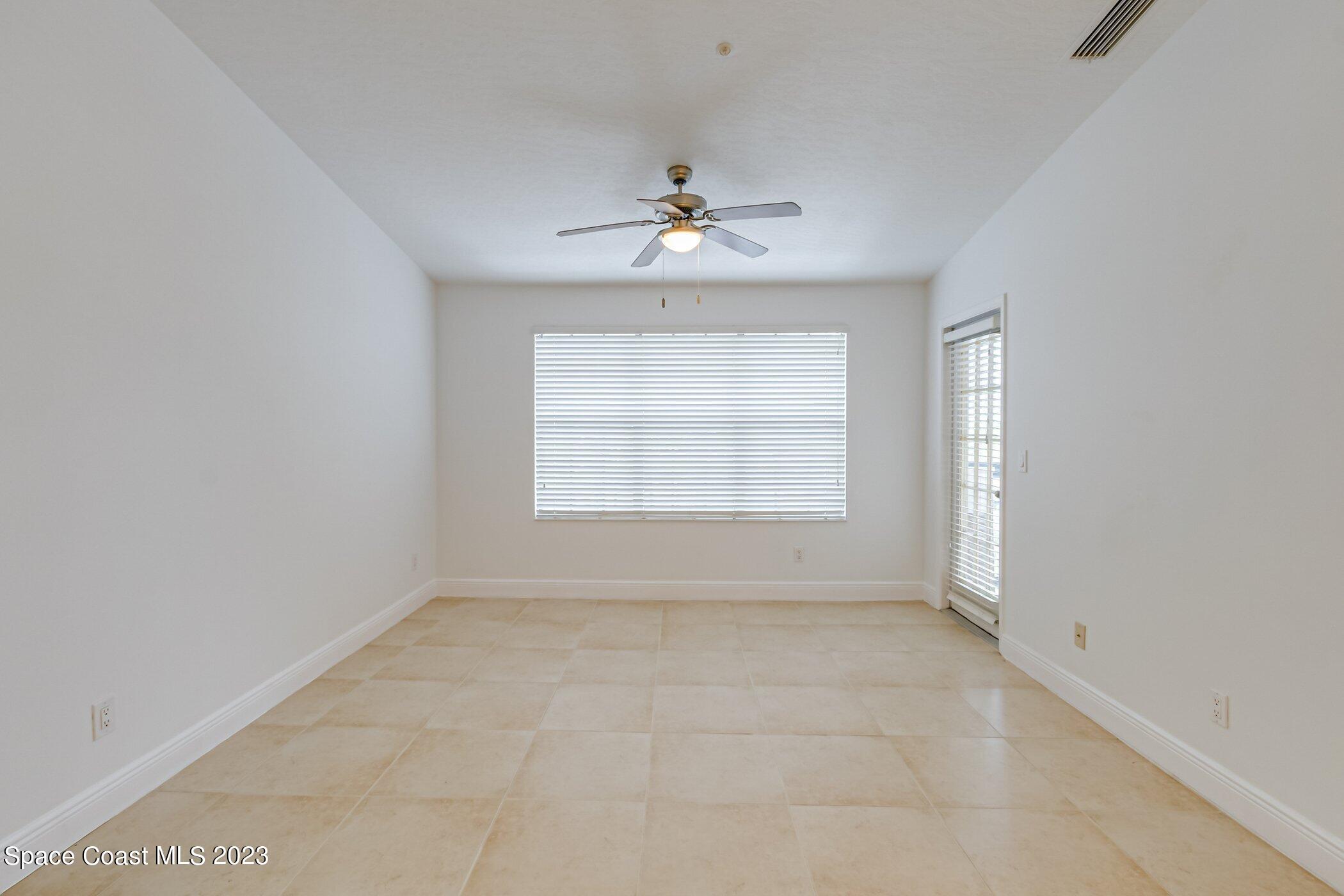 7667 North Wickham Road, Unit 617 Melbourne, FL 32940 - Photo 8 of 44 an empty room with a window and a ceiling fan