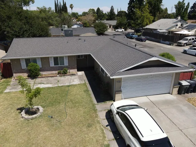a aerial view of a house with swimming pool and trees