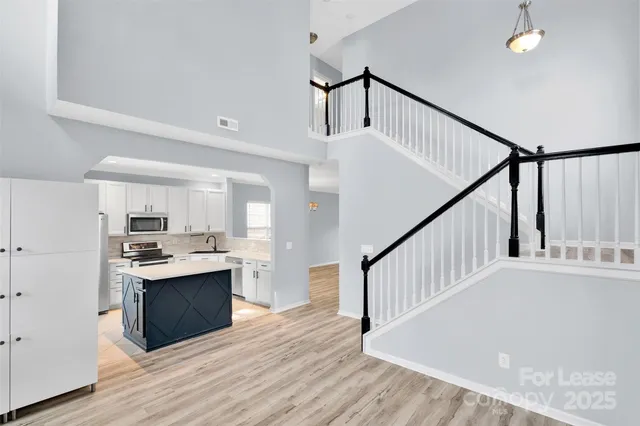 a view of kitchen with sink microwave and stove