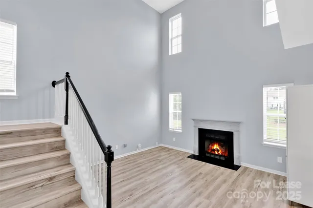 a view of an empty room and wooden floor fire place