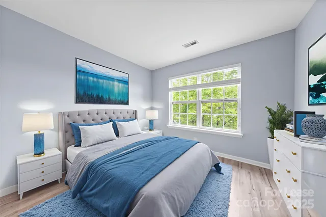 a bedroom with a large bed and a window