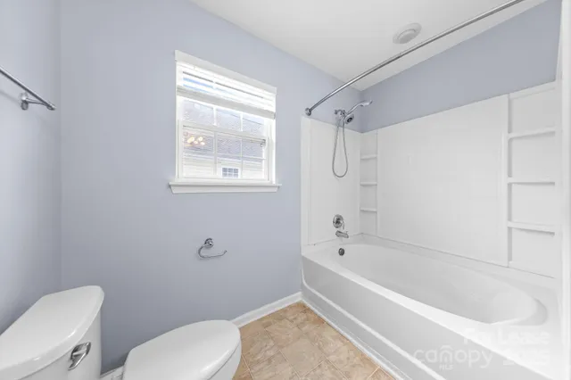 a bathroom with a toilet bathtub and shower