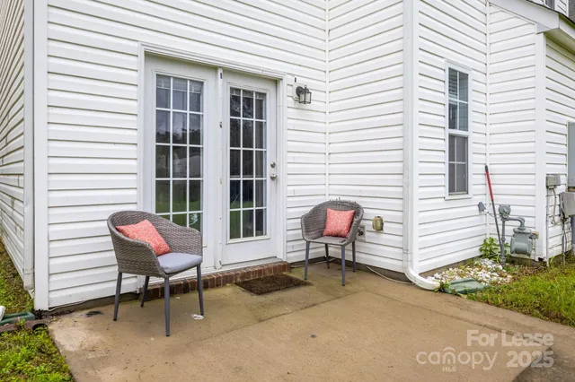 a view of a two chairs in front of house