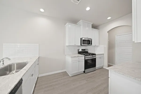 a kitchen with a sink stainless steel appliances and cabinets