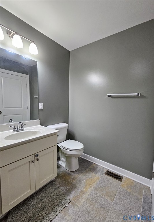 3286 Ranson Road Dillwyn, VA 23936 - Photo 12 of 25 a bathroom with a toilet sink and mirror
