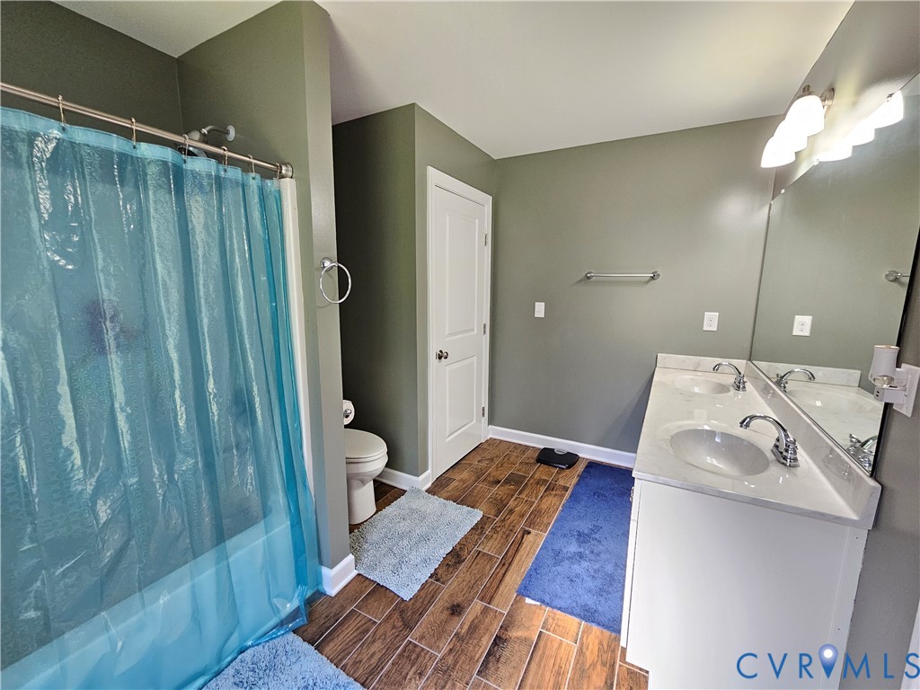 3286 Ranson Road Dillwyn, VA 23936 - Photo 13 of 25 a en suite bathroom with a sink and a mirror