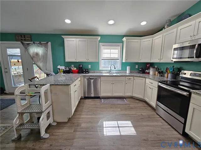 a kitchen with a sink cabinets and window