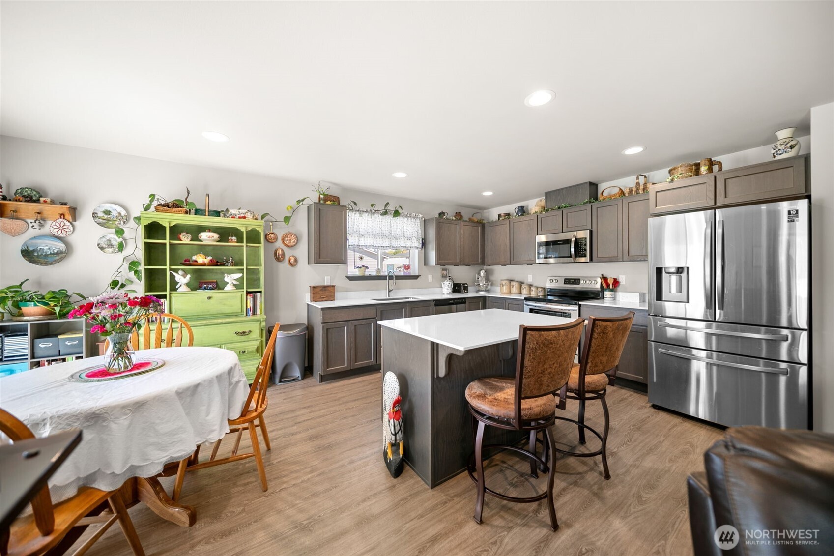 2314 Southeast Marlette Road East Wenatchee, WA 98802 - Photo 11 of 29 a kitchen with stainless steel appliances kitchen island granite countertop a dining table chairs and a refrigerator