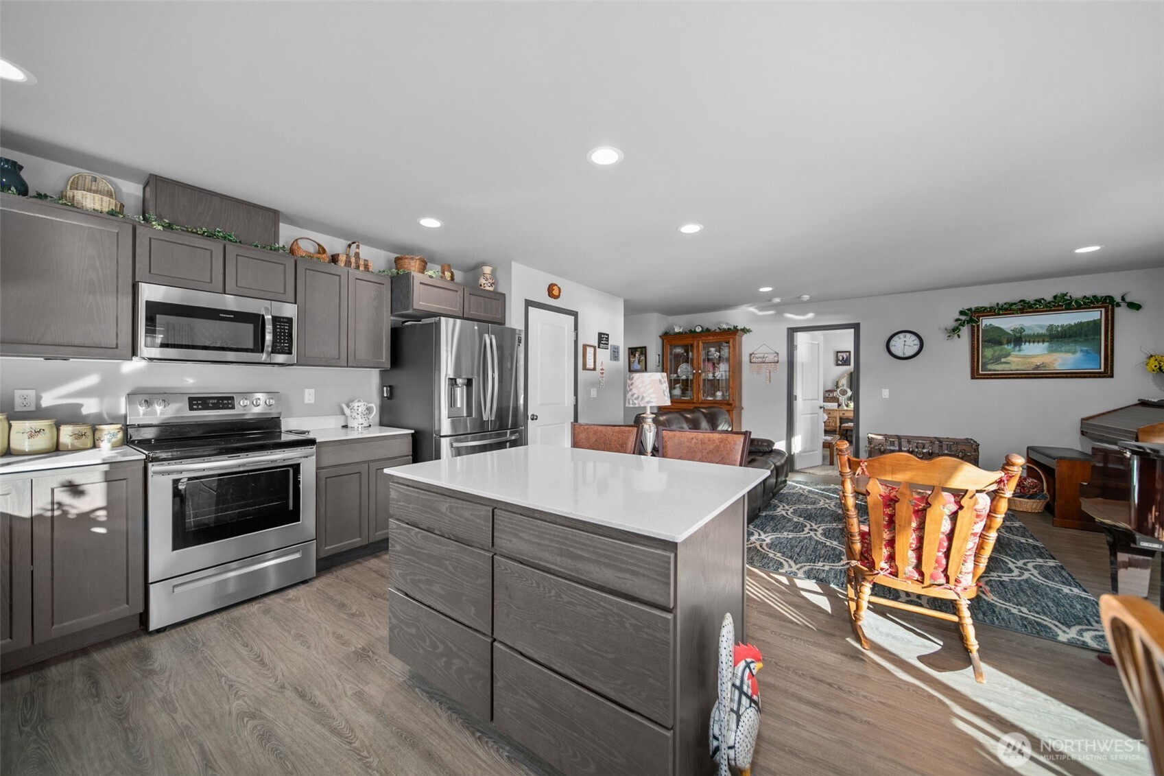2314 Southeast Marlette Road East Wenatchee, WA 98802 - Photo 7 of 27 a kitchen with stainless steel appliances kitchen island granite countertop a table chairs microwave and sink