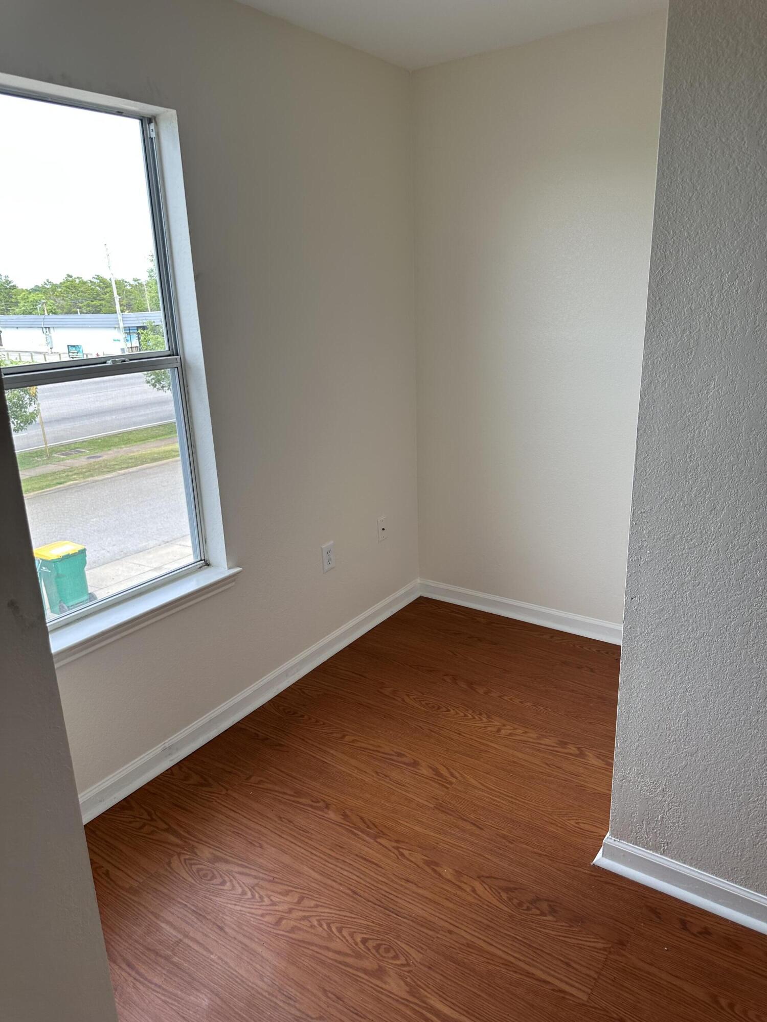 1150 Airport Road, Unit 138 Destin, FL 32541 - Photo 8 of 16 a view of a room with wooden floor and a window