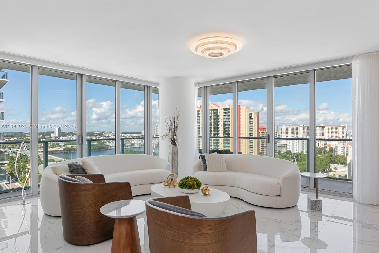 300 Sunny Isles Boulevard, Unit 41607 Sunny Isles Beach, FL 33160 - Photo 1 of 73 a living room with furniture and a floor to ceiling window