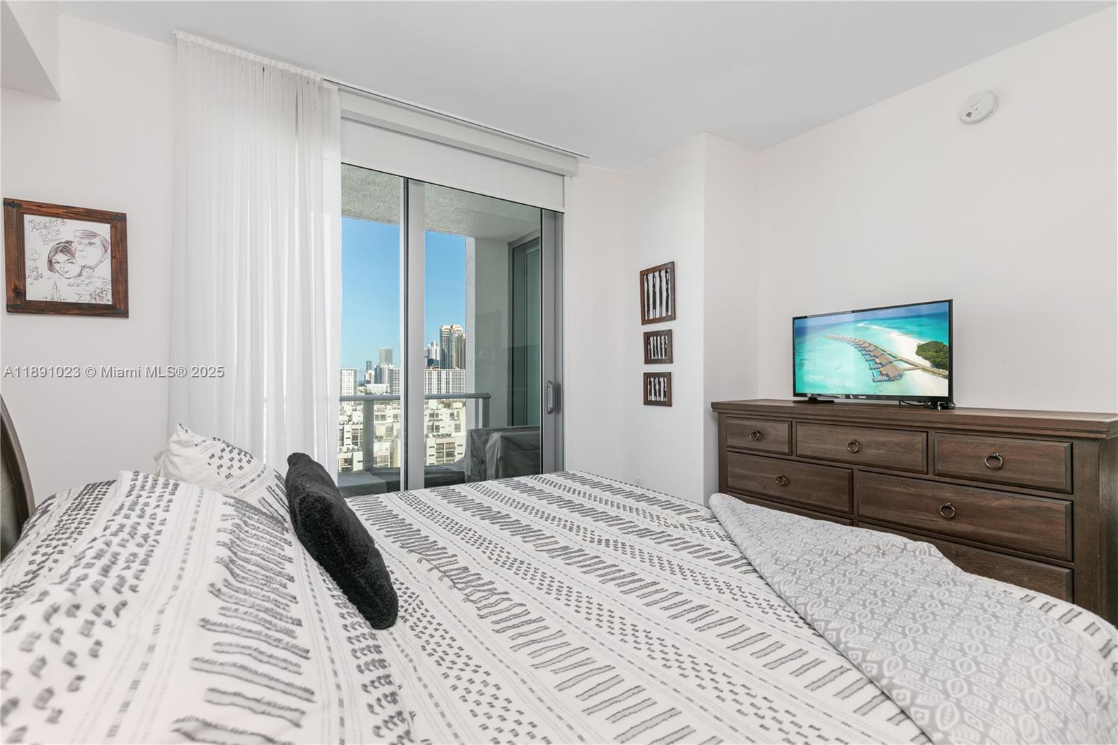300 Sunny Isles Boulevard, Unit 41607 Sunny Isles Beach, FL 33160 - Photo 15 of 73 a bedroom with a bed and a flat screen tv
