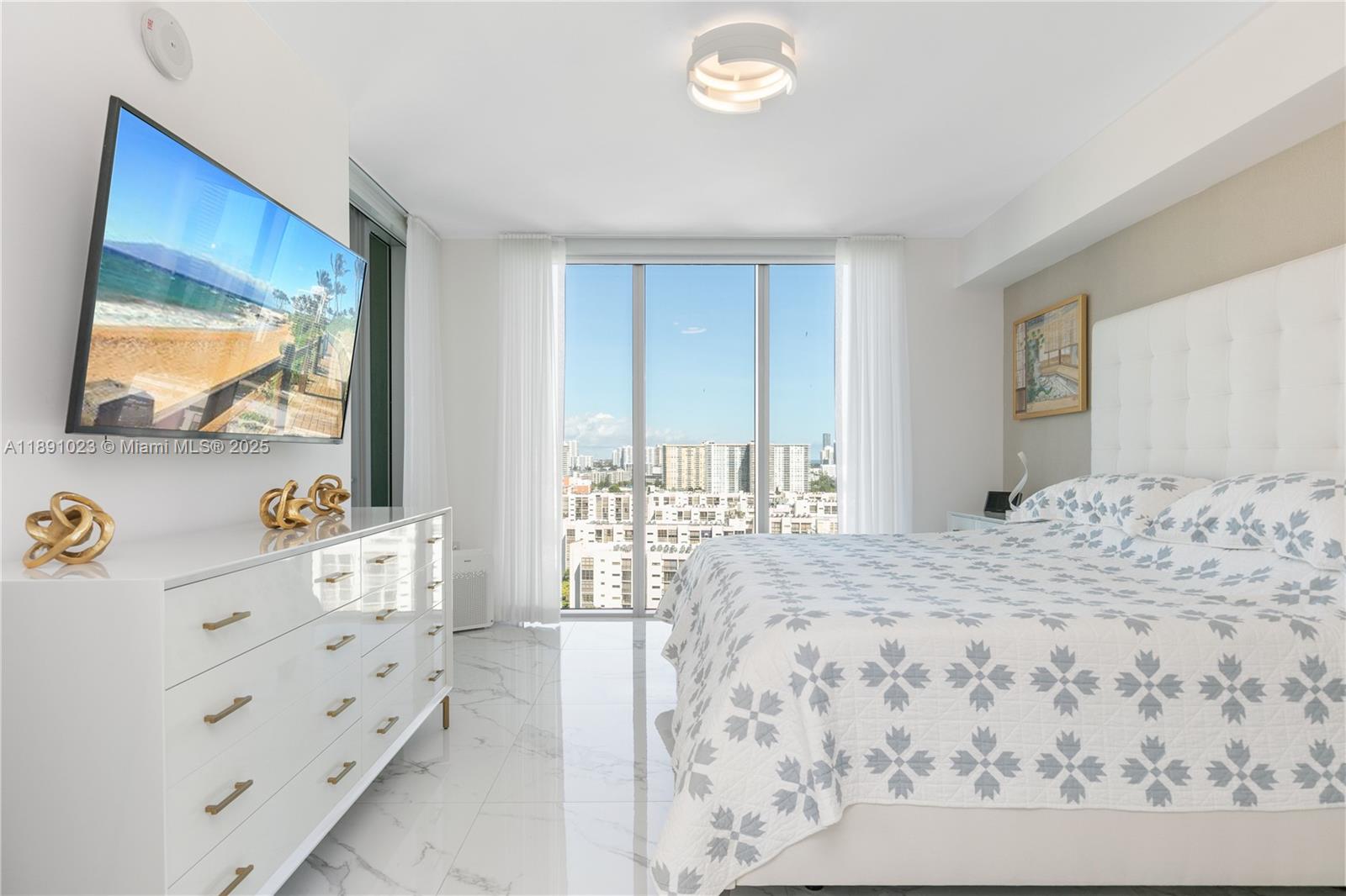 300 Sunny Isles Boulevard, Unit 41607 Sunny Isles Beach, FL 33160 - Photo 17 of 73 a bedroom with a bed and a flat screen tv