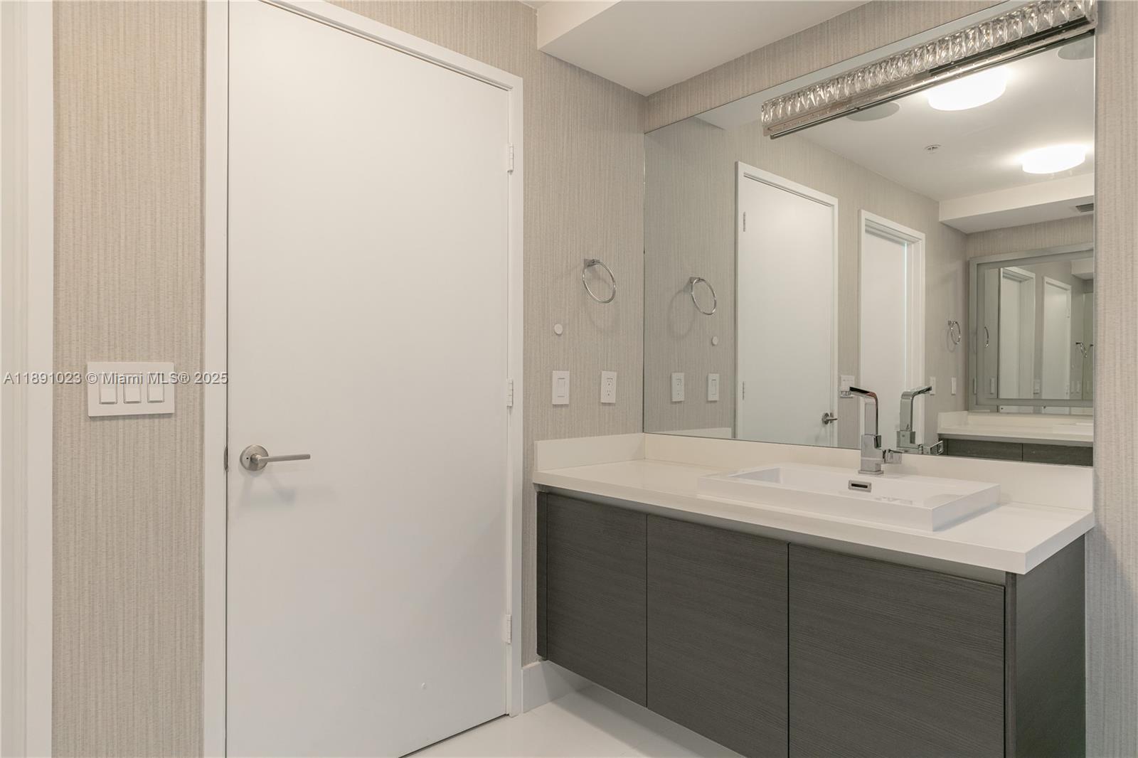 300 Sunny Isles Boulevard, Unit 41607 Sunny Isles Beach, FL 33160 - Photo 27 of 73 a bathroom with a sink and a mirror