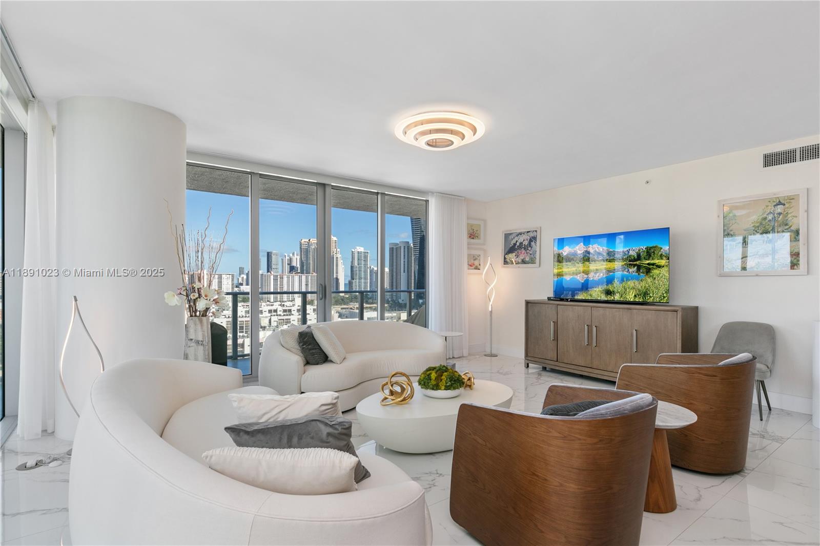 300 Sunny Isles Boulevard, Unit 41607 Sunny Isles Beach, FL 33160 - Photo 4 of 73 a living room with furniture and a flat screen tv