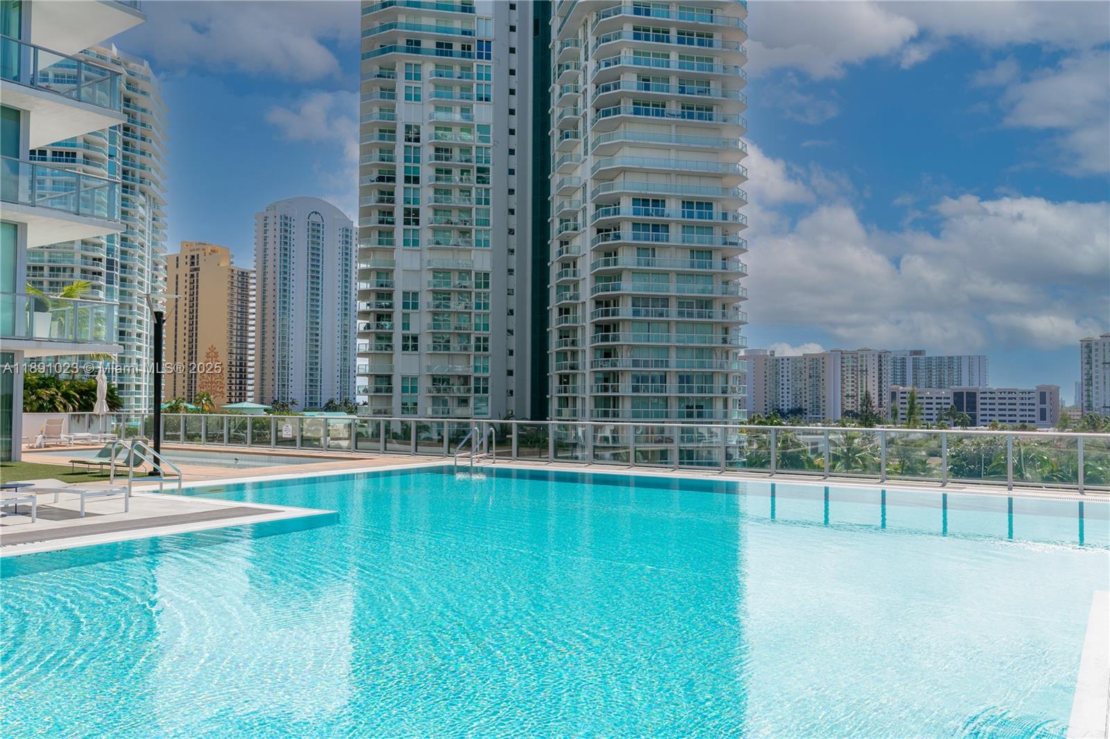 300 Sunny Isles Boulevard, Unit 41607 Sunny Isles Beach, FL 33160 - Photo 53 of 73 a swimming pool with outdoor seating and yard