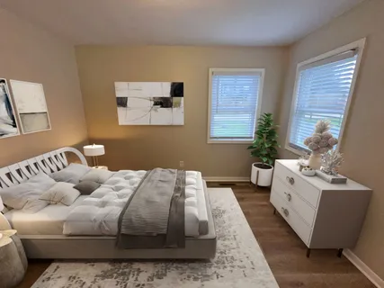 a bedroom with bed and window