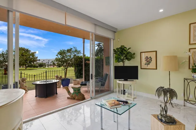 a living room with furniture and a floor to ceiling window
