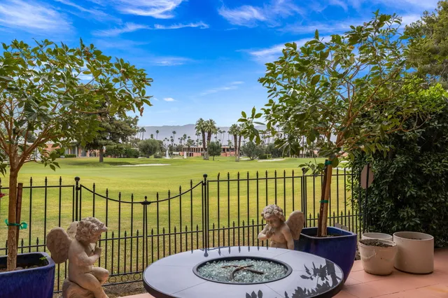 a view of a swimming pool and outdoor seating
