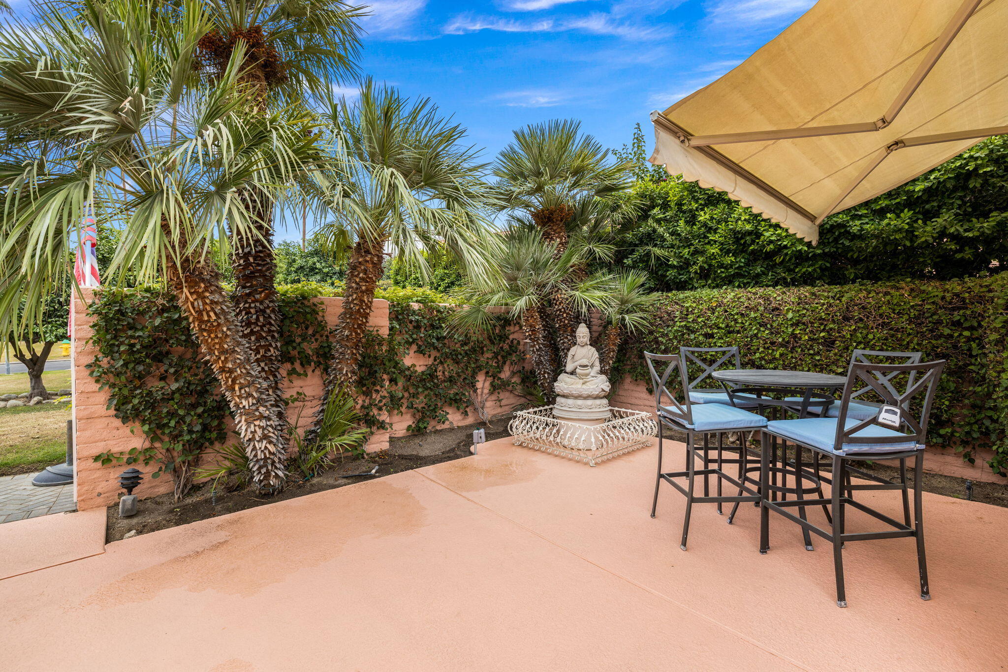 47432 Rabat Drive Palm Desert, CA 92260 - Photo 17 of 46 a patio with a yard table and chairs under an umbrella