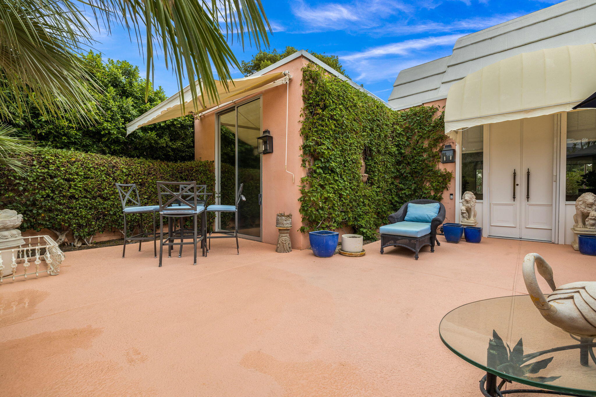 47432 Rabat Drive Palm Desert, CA 92260 - Photo 18 of 46 a view of a patio with a table and chairs and potted plants
