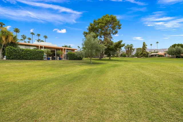 a view of a large building with an outdoor space and seating area