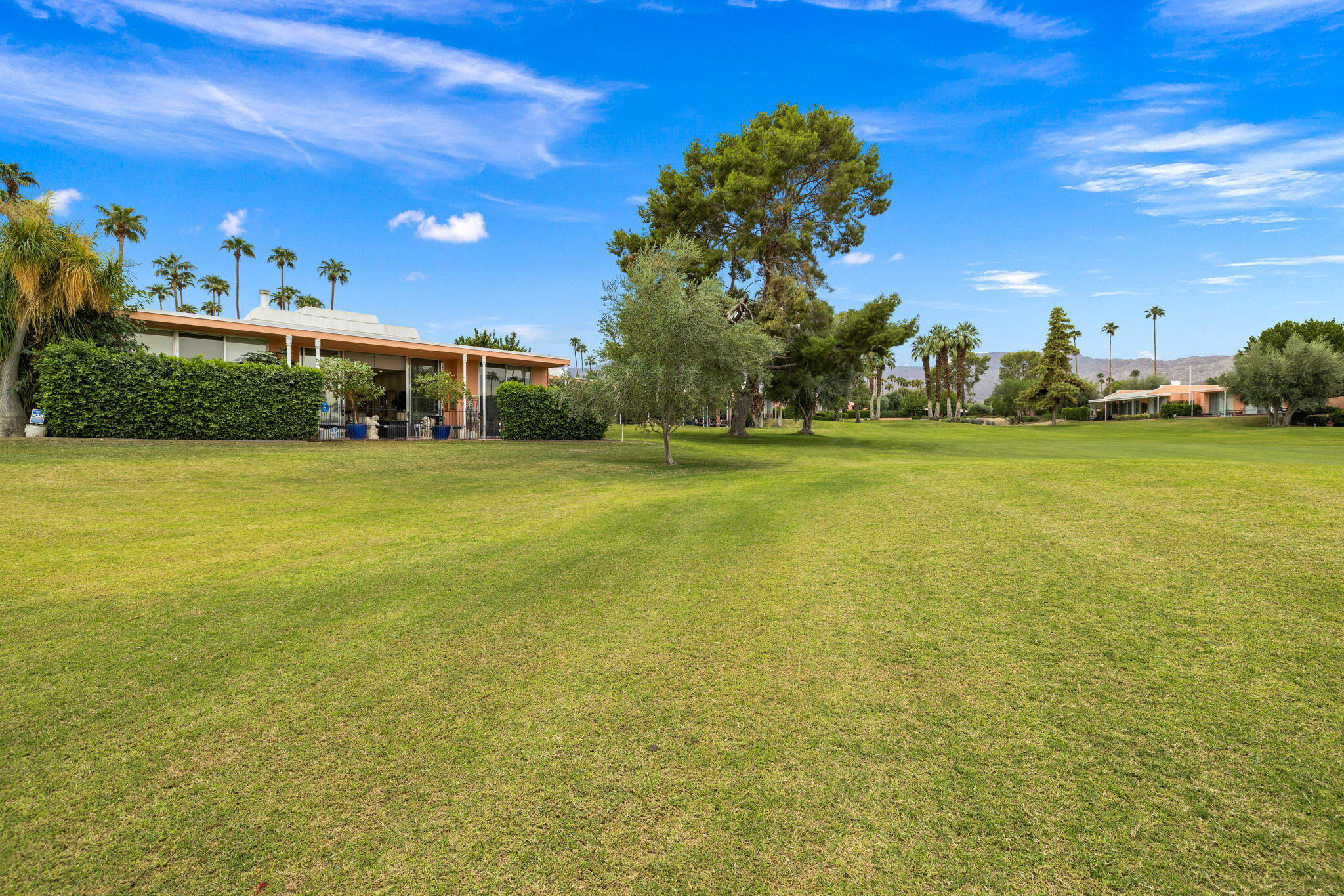 47432 Rabat Drive Palm Desert, CA 92260 - Photo 19 of 46 a view of a large building with an outdoor space and seating area