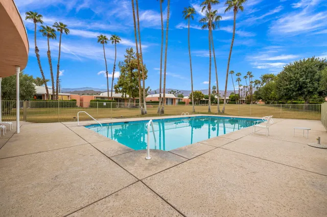 a view of a swimming pool with a lounge chairs