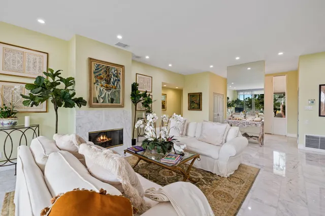 a living room with furniture fireplace and a table