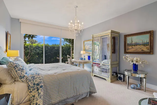 a bedroom with bed and a large window