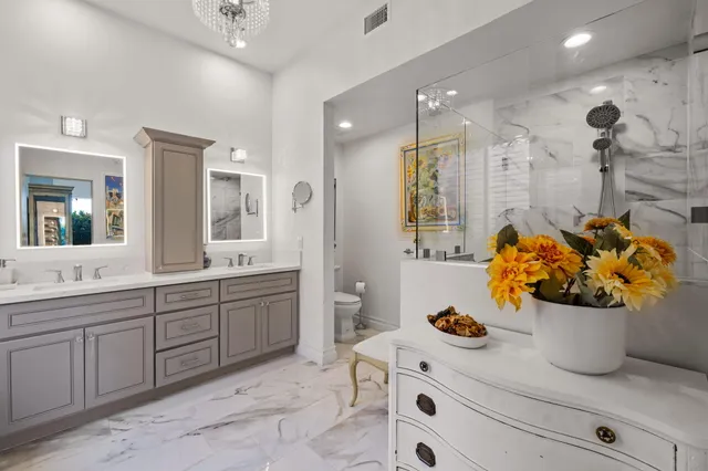 a bathroom with a sink mirror and vanity