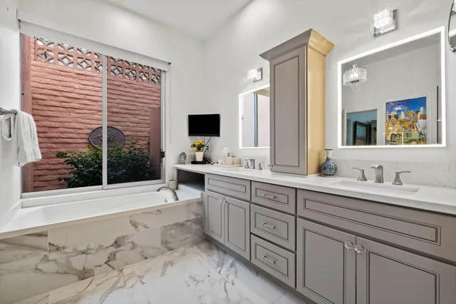a bathroom with a sink double vanity and a mirror