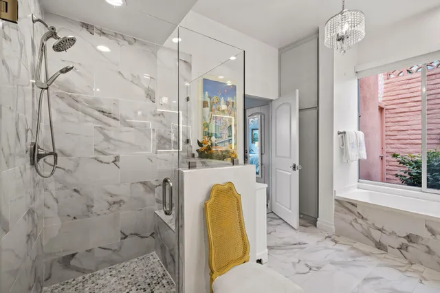 a bathroom with a tub shower and mirror