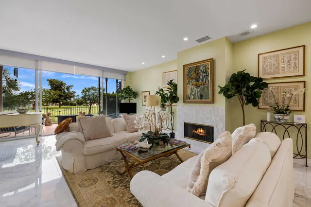 a living room with furniture fireplace and window