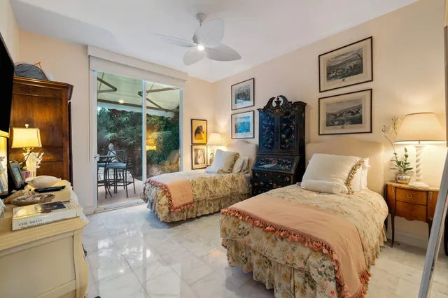 a bedroom with two beds and a chandelier