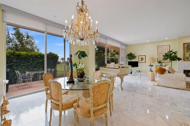 a dining room with furniture a chandelier and window