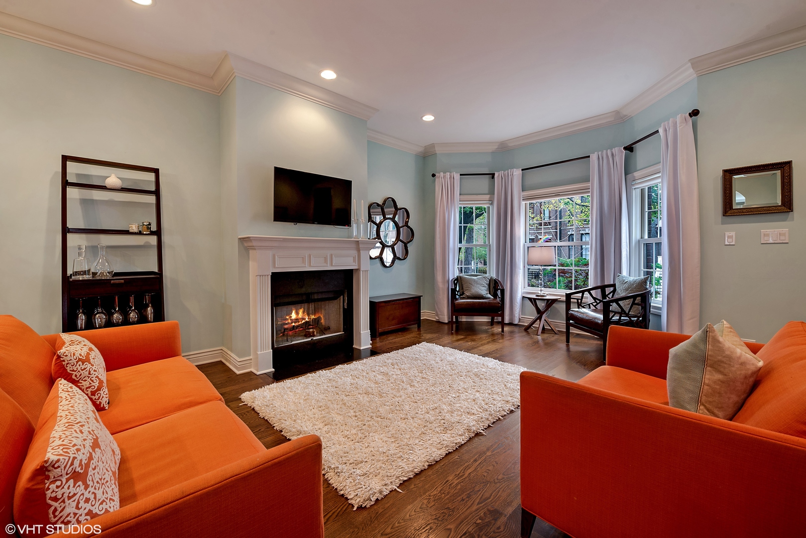1834 West School Street Chicago, IL 60657 - Photo 3 of 21 a living room with furniture a flat screen tv and a fireplace