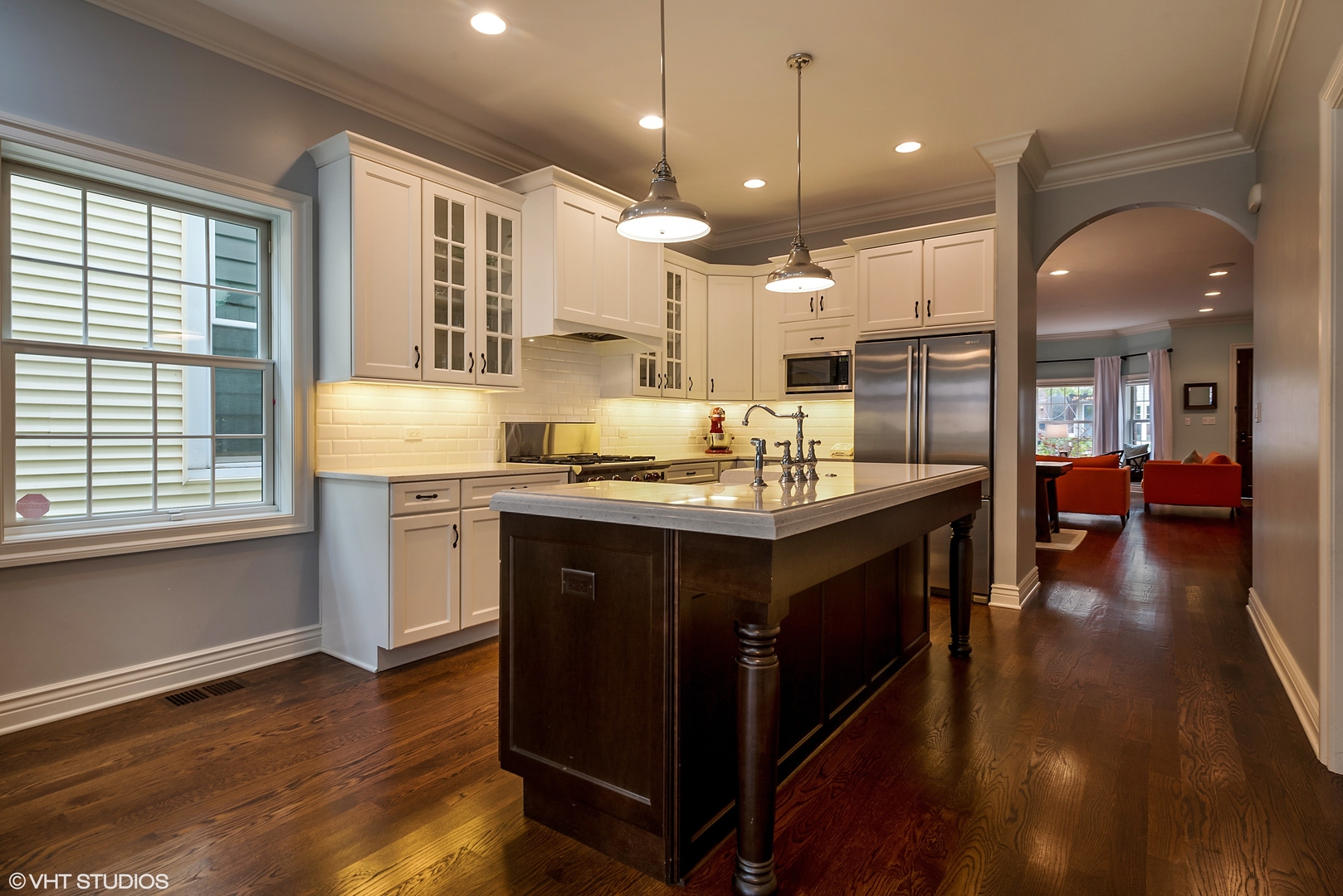 1834 West School Street Chicago, IL 60657 - Photo 6 of 21 a kitchen with kitchen island granite countertop a sink cabinets and wooden floor