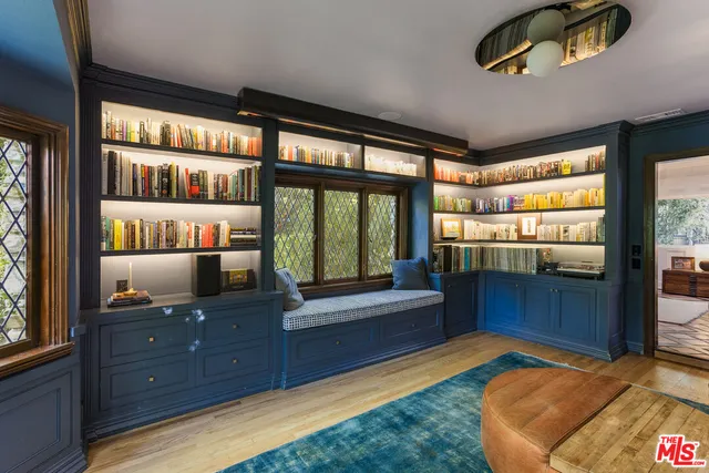 a living room with furniture and a floor to ceiling window