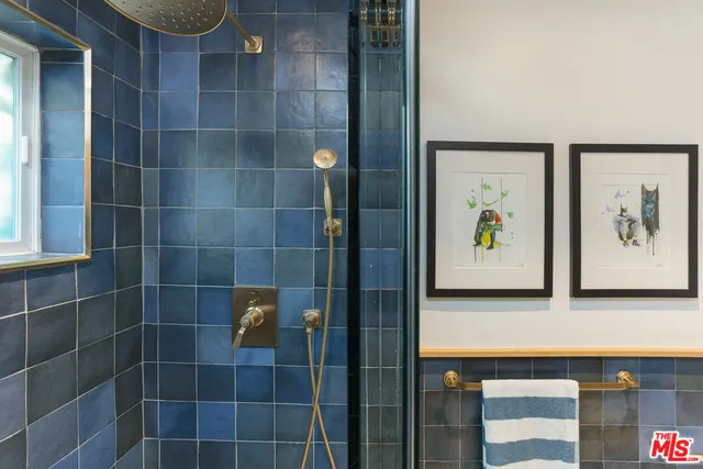 a bathroom with a shower and a sink