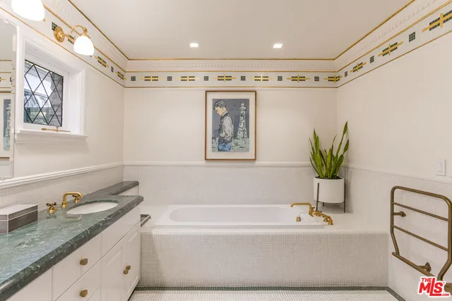 a bathroom with a granite countertop tub a sink and a shower