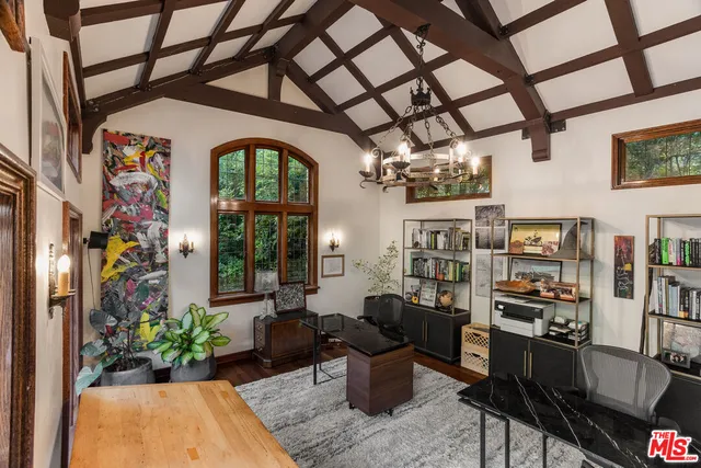 a living room with furniture and flowers