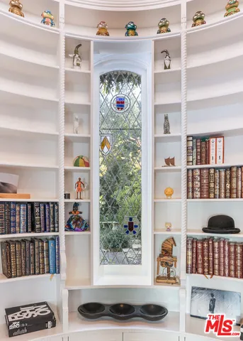 a living room with lots of furniture and a book shelf