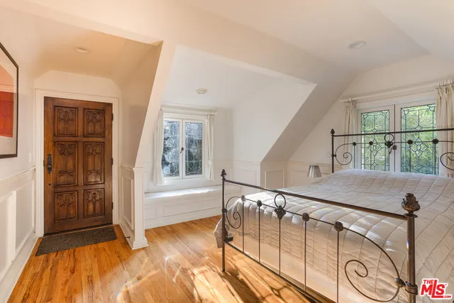 a view of front door with wooden floor and stairs