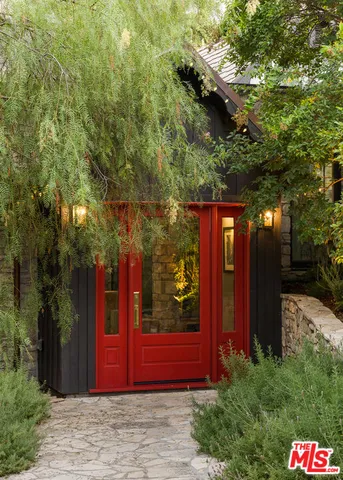 a view of a fountain with flower in front of house