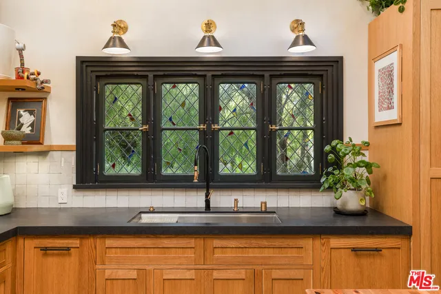 a view of a window with a sink and wooden floor