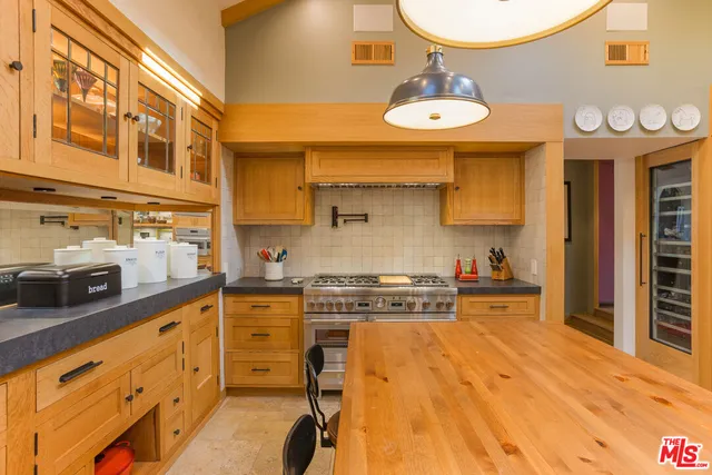 a kitchen with stainless steel appliances a stove a sink and a refrigerator