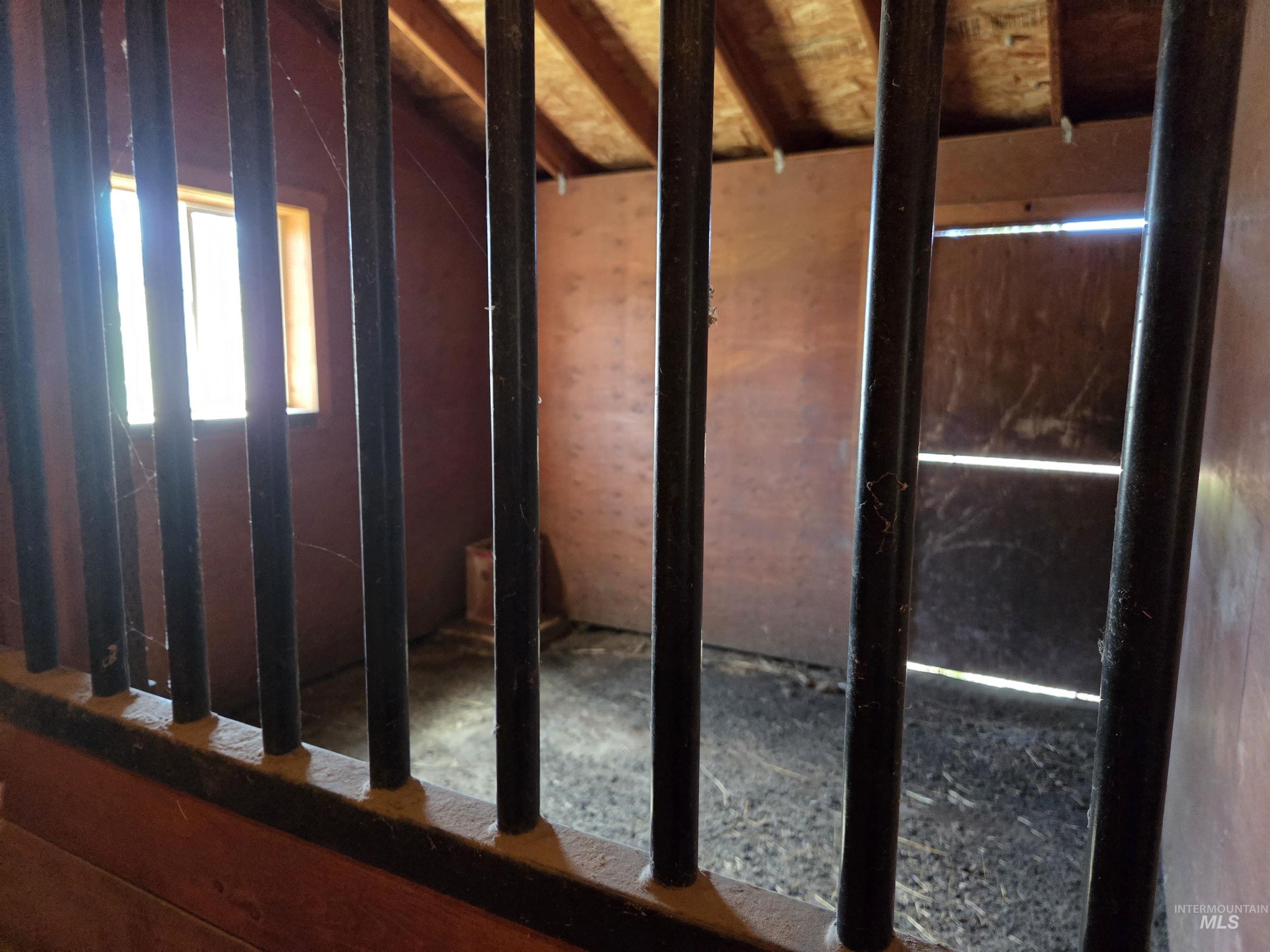 1085 Wallen Road Moscow, ID 83843 - Photo 41 of 50 Stall interior featuring exposed rafter ceiling, wood-paneled walls, and a window