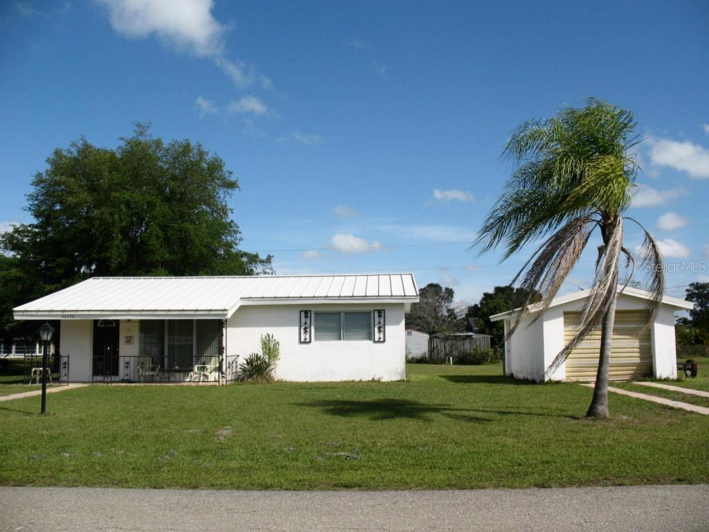 30238 Alder Road Punta Gorda, FL 33982 - Photo 1 of 1 a front view of a house with a garden