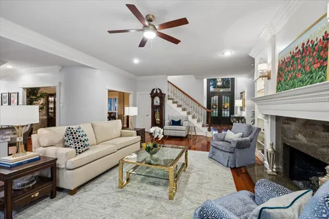 a living room with furniture fireplace and a window